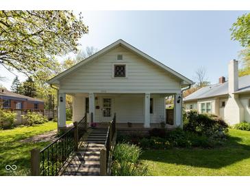 Charming home with a covered front porch, featuring a walkway and garden at 4710 Hinesley Ave, Indianapolis, IN 46208