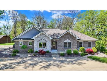 Beautiful brick home with stone accents and professionally landscaped front yard at 6149 W Olive Branch Rd, Greenwood, IN 46143