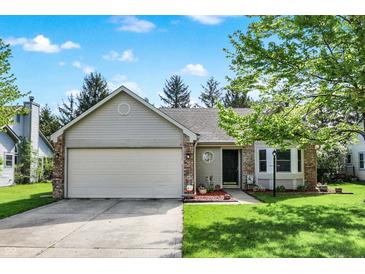 Charming single-story home boasts a well-manicured lawn and attached two-car garage, offering both curb appeal and convenience at 6257 Old Barn Ct, Indianapolis, IN 46268