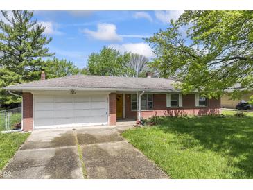 Charming single-story brick home with attached garage, well-maintained lawn, and classic architectural details at 7412 Hiner Ln, Indianapolis, IN 46219