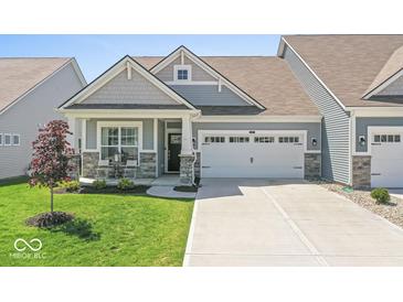 Charming single-story home featuring a two-car garage, covered porch, and well-maintained lawn at 75 Hovden Dr, Cicero, IN 46034