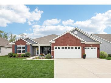 Charming brick and gray two-story home with well-maintained lawn and a two-car garage at 9359 Foudray N Cir, Avon, IN 46123
