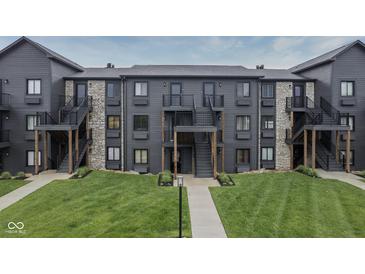 View of the exterior of a multi-Gathering building with stone accents and well-maintained landscaping at 102 Clarendon Dr # 506, Noblesville, IN 46062