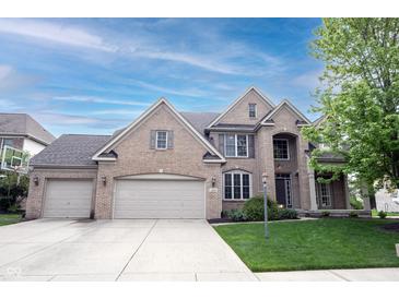 Charming brick two-story home with attached two-car garage and well-maintained lawn at 12493 Loudoun Pl, Fishers, IN 46037
