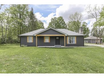 Charming single-story home featuring dark siding, light wood accents, and a well-maintained lawn at 1301 Stafford Rd, Plainfield, IN 46168