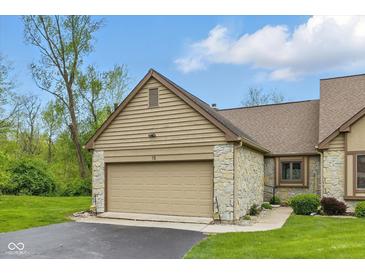 This home boasts a 2-car garage with a neutral door, stone accents, and manicured lawn at 15 Northridge Ct, Brownsburg, IN 46112
