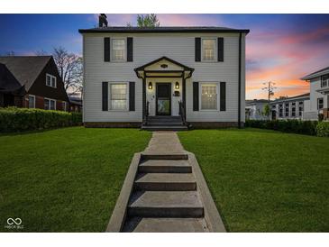 Charming two-story home featuring a well-manicured lawn and classic architectural details at 17 W Washington St, Mooresville, IN 46158