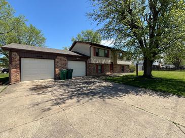 Charming two-story home featuring a spacious driveway and attached two-car garage at 1705 Witt Rd, Lebanon, IN 46052