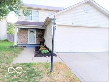 Charming two-story home featuring a brick facade, two-car garage and a meticulously landscaped yard at 5411 Cliff Ridge Dr, Indianapolis, IN 46217