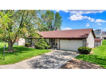 Charming single-story home features stone accents, mature trees, and a well-maintained lawn at 8141 Rob Ln, Indianapolis, IN 46237
