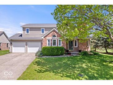 Charming two-story home with a two-car garage and well-maintained lawn at 11424 Geist Valley Dr, Indianapolis, IN 46236