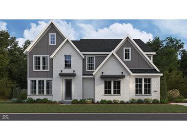 Charming two-story home with mixed material facade, including brick, and well-manicured lawn at 11801 Sage Creek Bnd, Fishers, IN 46037
