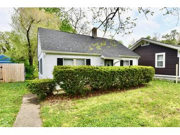 Charming one-story home with a manicured lawn, black shutters, and a gray roof in a beautiful, suburban setting at 3109 Forest Manor Ave, Indianapolis, IN 46218