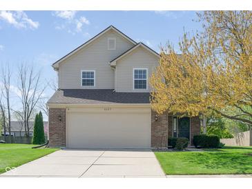 Charming two-story home featuring a brick and vinyl facade, attached garage, and well-manicured lawn at 4625 Elkhorn Ct, Noblesville, IN 46062