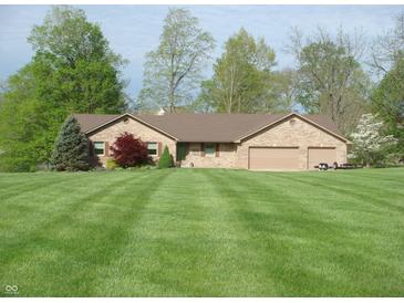 Charming brick ranch home featuring a large, manicured front lawn and two-car garage at 4806 Krestridge E Ct, Bargersville, IN 46106