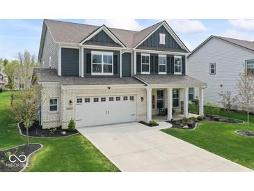 Beautiful two-story home with a well-manicured lawn, two car garage, and inviting front porch at 5363 Citadel Dr, Noblesville, IN 46062