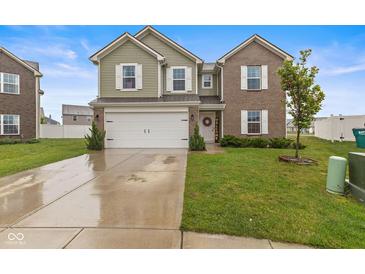 Charming two-story home featuring a manicured lawn, two car garage, and welcoming front porch at 5845 Cresswell Ln, Whitestown, IN 46075