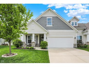 Charming home featuring a well-maintained lawn, attached two-car garage and inviting front porch at 6241 Colonial Dr, Whitestown, IN 46075