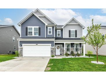 Beautiful two-story home with blue and gray siding, stone accents, and a well-manicured lawn at 8811 Dorill Creek Ln, Indianapolis, IN 46259