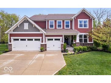 Beautiful two-story home featuring a three-car garage and well-manicured lawn at 10531 Cleary Trce, Fishers, IN 46040