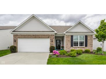 Charming brick home featuring an attached garage, manicured lawn, and a welcoming front entrance at 16044 Loire Valley Dr, Fishers, IN 46037