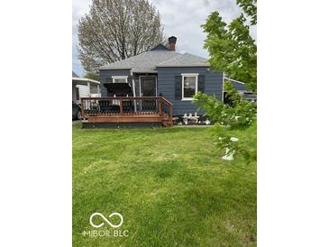 Charming home featuring a cozy front porch and well-manicured lawn at 1623 Oliver Ave, Indianapolis, IN 46221