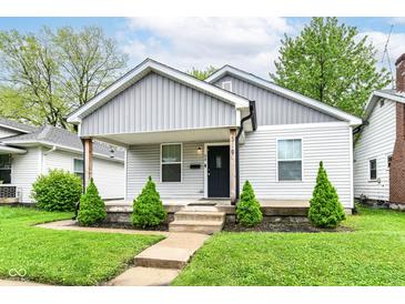Charming home featuring a covered porch, tidy landscaping and freshly painted exterior at 319 S Randolph St, Indianapolis, IN 46201