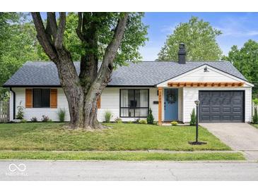 Charming single-story home featuring a tidy front lawn, blue door, and gray garage at 3864 Esquire Ct, Indianapolis, IN 46226