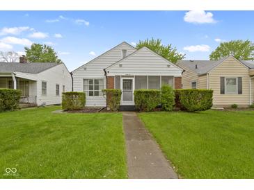 Charming home featuring lush green lawn, and decorative hedges enhance the curb appeal at 46 N Kitley Ave, Indianapolis, IN 46219