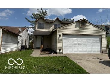 Two-story home with a two car garage and a well-maintained front lawn at 5327 Traditions Dr, Indianapolis, IN 46235