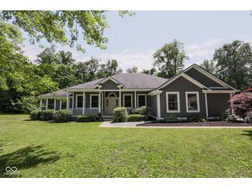 Charming single-story home with a welcoming front porch and well-manicured lawn at 5607 E 500 N, Greenfield, IN 46140