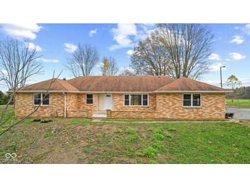 Charming brick home featuring a cozy front porch and well-maintained lawn at 647 N 100 W, Franklin, IN 46131