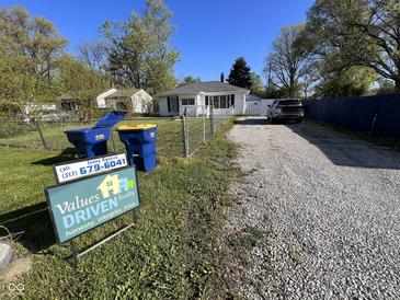 Charming single-story home with a gravel driveway and a well-maintained front lawn at , Indianapolis, IN 46226