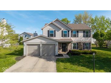 Charming two-story home with a well-maintained lawn, two-car garage, and traditional design elements at 950 Hearthside Dr, Brownsburg, IN 46112