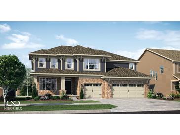 Charming two-story home boasts brick accents, a three-car garage, and a welcoming front yard at 11612 Aubrey Ln, Fishers, IN 46040