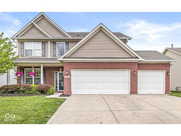 Charming two-story brick home with a two-car garage and manicured landscaping at 4264 Amesbury Pl, Noblesville, IN 46062