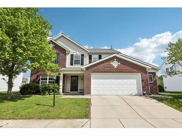 Charming two-story home featuring a brick facade, white siding, and a spacious two-car garage at 5876 E 126Th St, Carmel, IN 46033