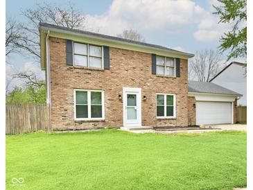 Charming two-story brick home with a well-maintained lawn and attached two-car garage at 6352 Watercrest Way, Indianapolis, IN 46278