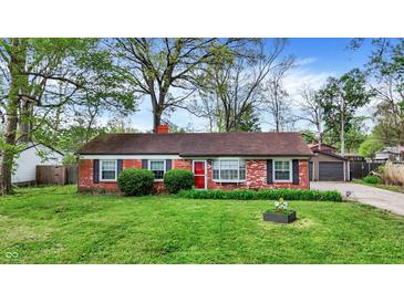 Charming brick home features a well-maintained lawn, red door, and neat landscaping at 6837 Doris Dr, Indianapolis, IN 46214