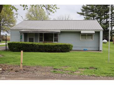 Charming single-story home featuring light blue siding and well-maintained landscaping at 8341 N Washington St, Sheridan, IN 46069