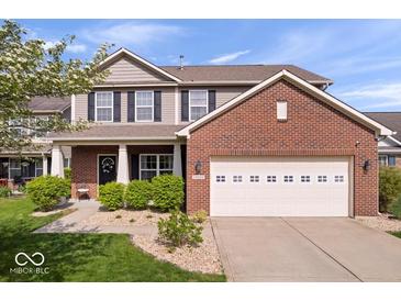 Charming two-story home featuring a well-manicured lawn, brick accents, and an attached two-car garage in a residential area at 15332 Atkinson Dr, Noblesville, IN 46060