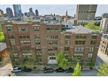 Exterior front of building shows architectural details and landscaping at 430 N Park Ave # 103, Indianapolis, IN 46202