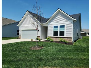 Charming one-story home featuring a well-manicured lawn, attached garage, and stylish white siding at 4734 Cleome Dr, Plainfield, IN 46168