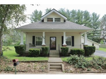 Charming home with a welcoming porch swing and nicely landscaped front yard at 489 Highland St, Morgantown, IN 46160