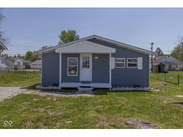 Charming single-story home with blue siding, a white front door, and well-maintained landscaping at 5515 W Morris St, Indianapolis, IN 46241
