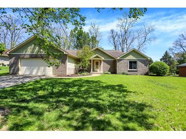 Charming brick home with a lush green lawn and an attached two-car garage at 601 Shady Ln, Greenwood, IN 46142