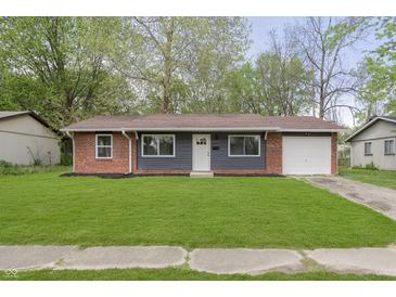 Charming single-story home with a brick and siding exterior and well-maintained lawn at 10132 E 33Rd St, Indianapolis, IN 46235