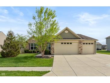 Beautiful single-story home featuring a three-car garage, stone accents, and a well-manicured lawn at 131 Stamford Dr, Pittsboro, IN 46167
