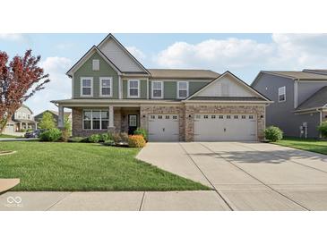 Charming two-story home with a brick and siding exterior, manicured lawn and an attached two-car garage at 16112 Lavina Ln, Fishers, IN 46040