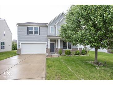 Charming two-story home with an attached garage and well-maintained lawn at 2006 Creek Bank Dr, Columbus, IN 47201